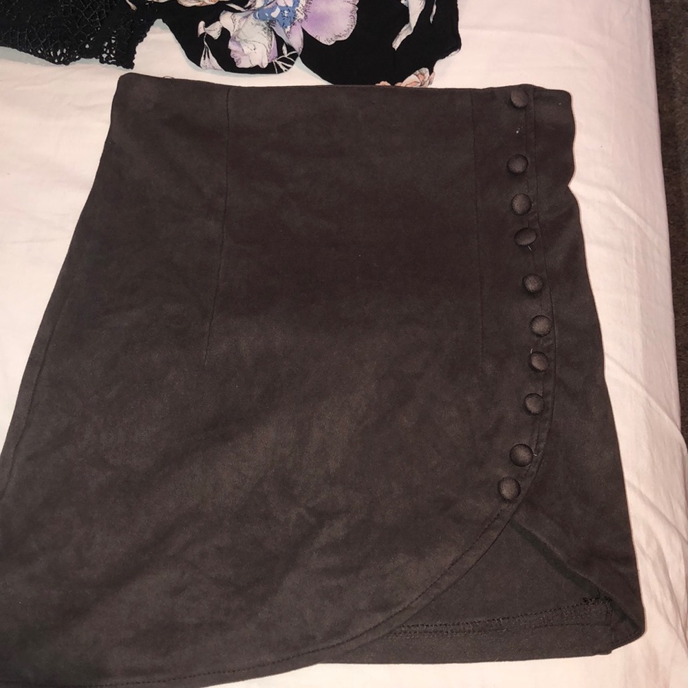 Suede skirt with thigh high buttons.